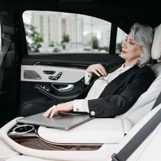 Elegant interior of a Lincoln Town Car sedan with spacious leather seats and ambient lighting, highlighting comfort and luxury of Ayr Airport Limo service.